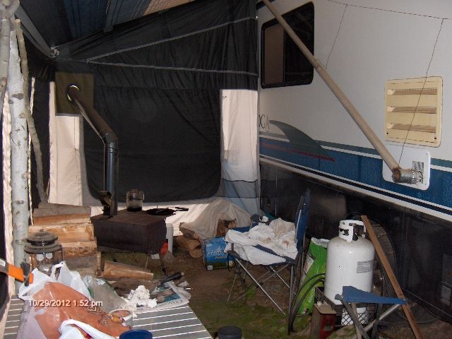 Just in the door of the awning setup, with the stove.