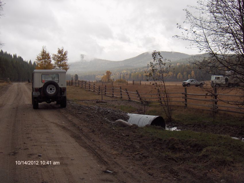 The Jeep entering the first meadow and a local loading cattle.